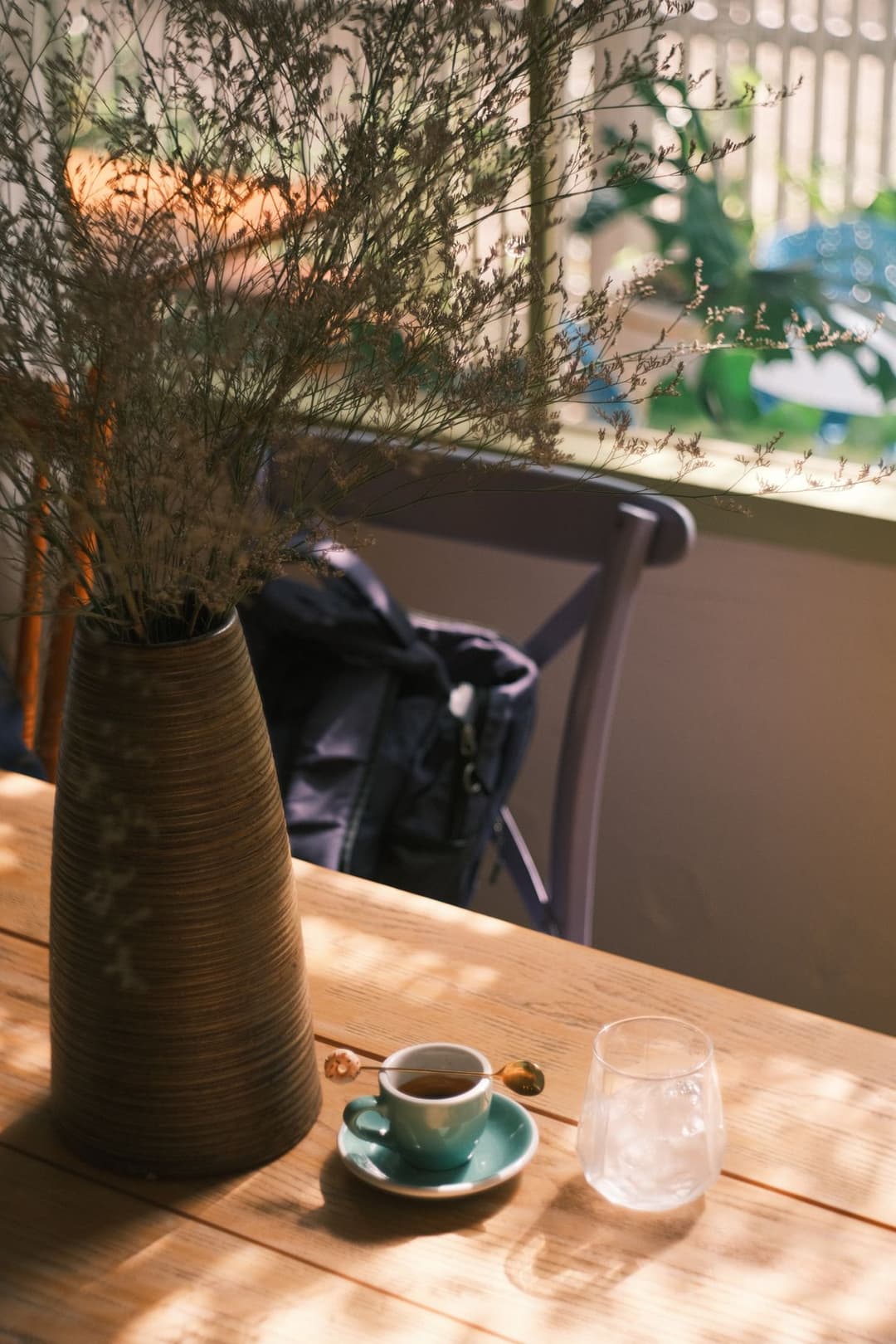 A sunlit café table set for guests