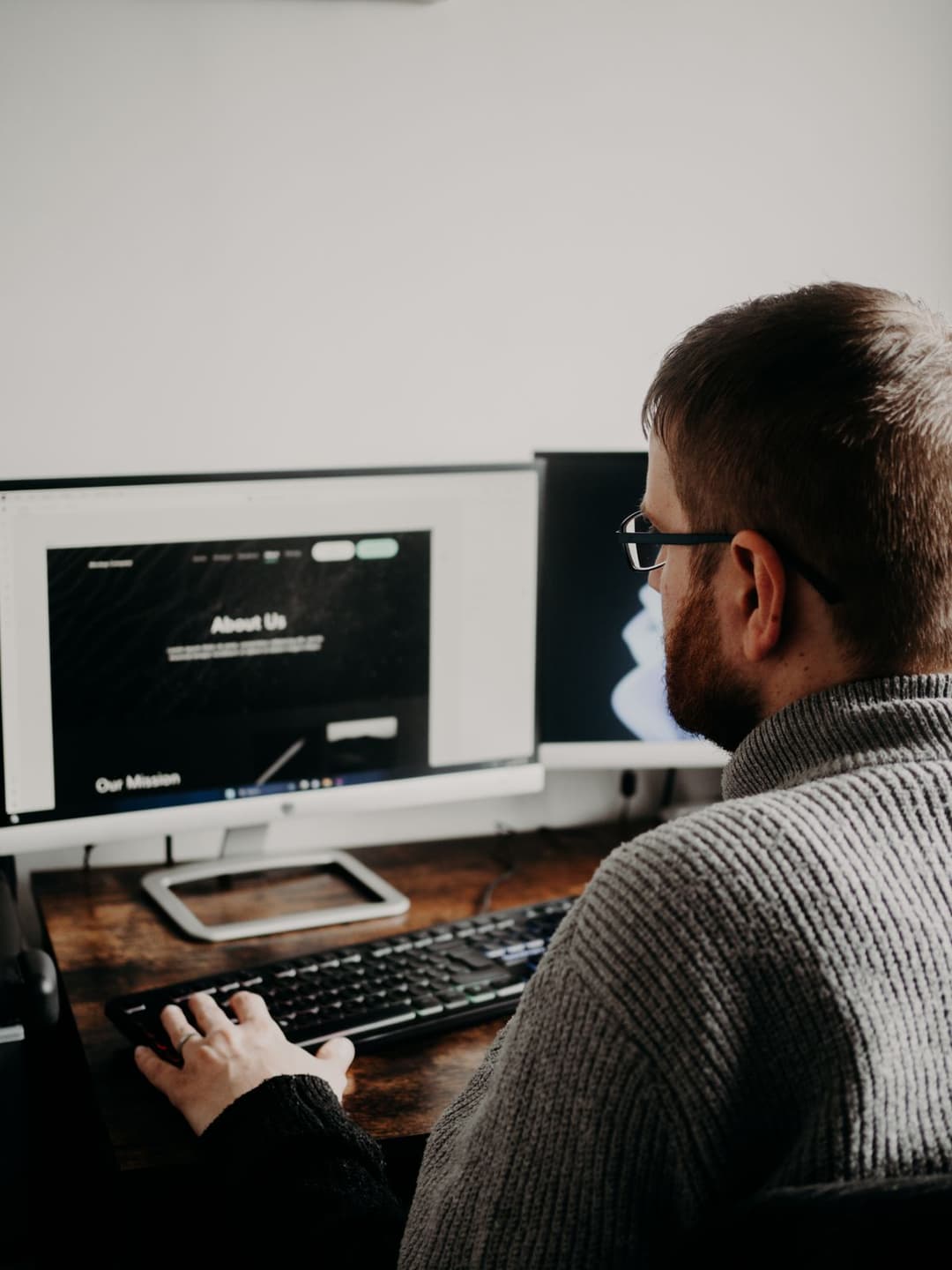 A designer reviewing a website layout on a monitor