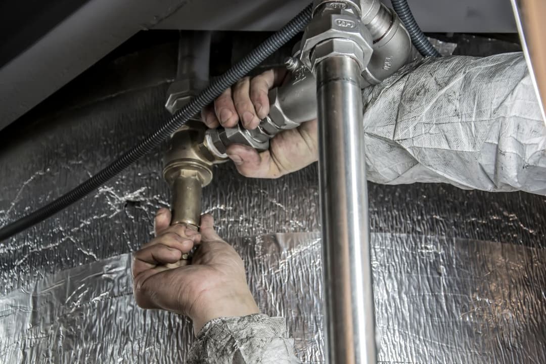 A plumber installing steel pipes