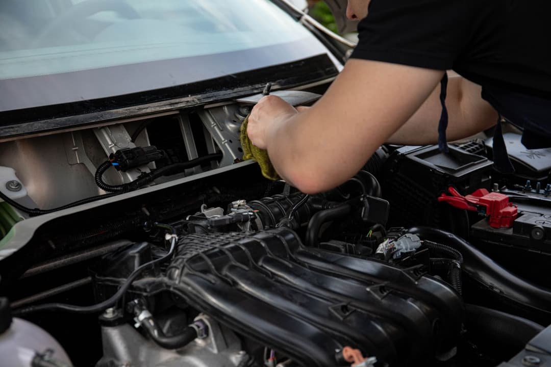 A mechanic working on a car engine