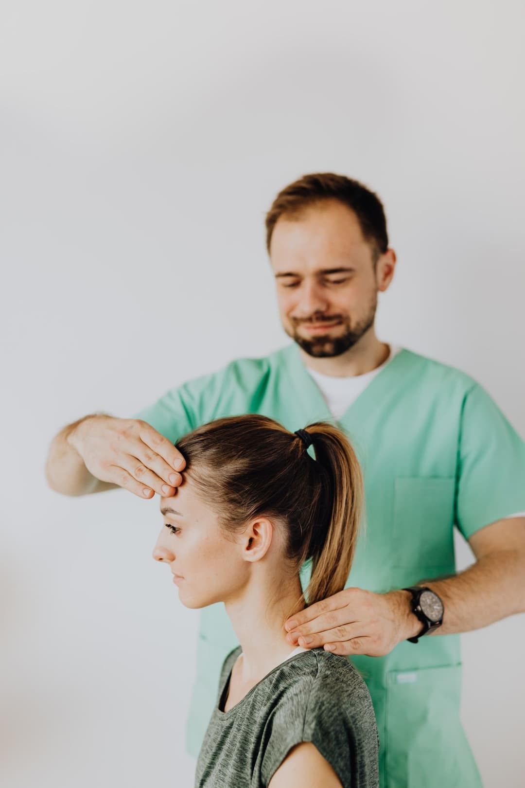 A chiropractor treating a patient's neck