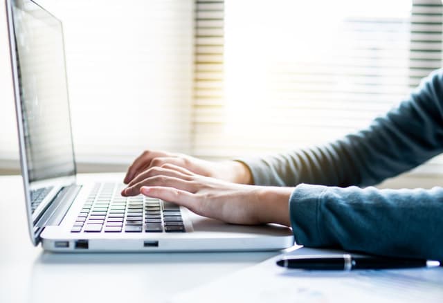Typing a reply on a laptop
