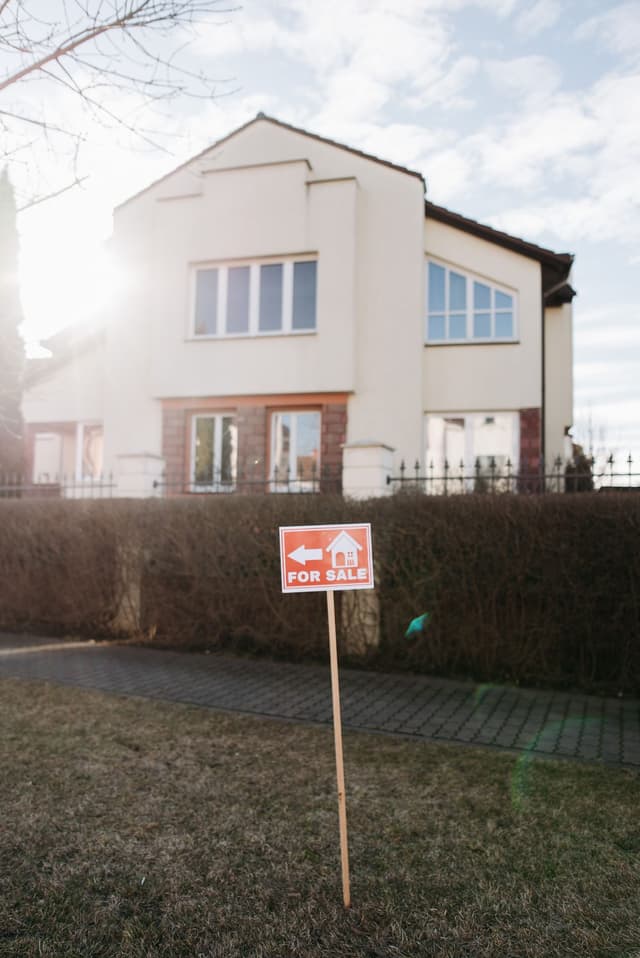 A house with a for sale sign in the yard